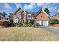 Charming two-story brick home featuring an attached two-car garage and manicured landscaping at , Suwanee, GA 30024