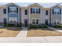 Charming townhomes featuring modern exteriors with landscaped front yards and inviting entryways at 310 Ashigan St, Union City, GA 30291