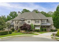 Stately home with stone accents, manicured lawn, and charming curb appeal in a lush, green neighborhood at 5119 Greythorne Ln, Marietta, GA 30068