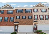 Charming townhomes with brick facades, attached garages, and professionally maintained landscaping at 2237 Foley Park St, Snellville, GA 30078