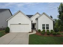 Charming single-story home showcasing a well-manicured lawn and an attached two-car garage at 5320 Coltman Dr, Cumming, GA 30028