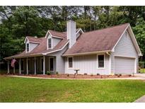 Charming gray home with a two-car garage, dormer windows, and well-maintained lawn at 60 Valley Rd, Covington, GA 30016