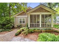 Charming craftsman home featuring a screened-in porch and beautiful landscaping at 4649 Dahlia Dr, Pine Lake, GA 30072
