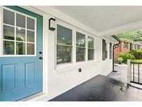 Inviting front entrance with blue door and white brick facade with large windows at 163 Oakcliff Ct, South Fulton, GA 30331
