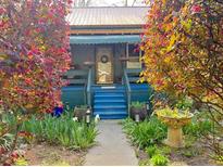 Charming home featuring a welcoming entrance, lush landscaping, and colorful foliage creating inviting curb appeal at 23 Gould Se St, Atlanta, GA 30315