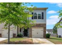 Charming two-story home with stone accents, a single-car garage, and a neatly maintained front yard at 635 Oakside Pl, Acworth, GA 30102