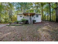 Cozy home featuring a small front porch with natural surroundings at 12 Woodland St, Dallas, GA 30157