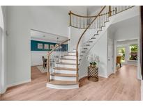 Elegant foyer with curved staircase, hardwood floors, and views of the dining room at 2500 Madison Commons, Atlanta, GA 30360