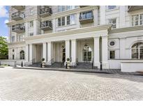 Elegant building entrance with stately columns and decorative landscaping for an inviting arrival at 195 14Th Ne St # 1706, Atlanta, GA 30309