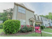 Charming townhome featuring well-maintained landscaping and neutral siding for a welcoming curb appeal at 3474 Washington Way, Atlanta, GA 30340