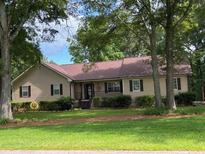 Charming single-story home featuring a welcoming entrance, well-manicured landscaping, and a neatly kept front lawn at 3594 Saddlebrook Dr, Loganville, GA 30052