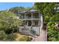Stunning two-story home featuring double balconies, lush landscaping, and a welcoming front entrance at 805 Ponce De Leon Ne Ter, Atlanta, GA 30306
