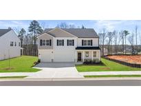 Charming two-story home with a two-car garage, well-manicured lawn, and traditional architectural details at 1950 Van Allen Ct, Dacula, GA 30019