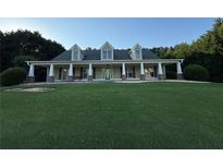 Charming single-Gathering home with an expansive lawn, a welcoming front porch, and well-maintained landscaping at 130 Honey Ln, Fayetteville, GA 30214