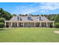 Charming one-story home with a large, inviting front porch and well-manicured lawn at 130 Honey Ln, Fayetteville, GA 30214