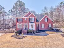 Charming two-story red brick home featuring a well-manicured lawn and inviting front entrance at 4213 Bretdale Nw Run, Kennesaw, GA 30152