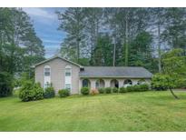 Charming brick home featuring a well-manicured lawn and lovely landscaping that enhances its curb appeal at 4244 Dorsey Sw Ct, Lilburn, GA 30047