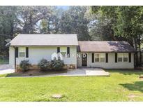 Charming single-story home with light siding, black shutters, and a well-maintained front yard with mature trees at 5243 Valleyview Dr, Acworth, GA 30102