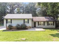 Charming single-story home with light-colored siding, black shutters, and a well-maintained lawn at 5243 Valleyview Dr, Acworth, GA 30102