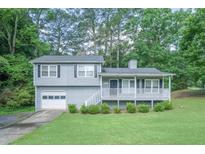 Charming two-story home with a welcoming front porch and well-maintained lawn at 2650 Montego Dr, Buford, GA 30519