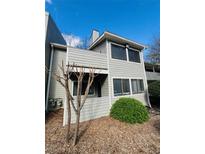 Charming two-story condo featuring tidy landscaping and a private covered deck at 3432 Ivys Walk, Atlanta, GA 30340