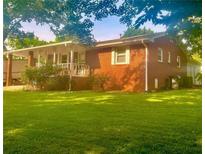 Charming brick home with a covered porch and a spacious front yard perfect for outdoor activities at 3629 Centerview Dr, Marietta, GA 30066