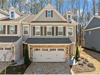 Beautiful two-story townhome with a two-car garage and charming architectural details at 495 Duval Dr, Alpharetta, GA 30009
