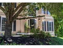 Charming home featuring a black front door, lush landscaping, and inviting curb appeal at 235 Foxley Way, Roswell, GA 30075