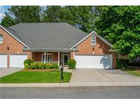 Charming single-story brick home features an attached two-car garage and manicured front lawn at 8675 Hope Vine, Roswell, GA 30076