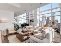 Bright living room featuring a modern design, floor-to-ceiling windows, and a grand piano overlooking the city at 45 Ivan Allen Jr Nw Blvd # 2705, Atlanta, GA 30308