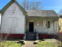 Exterior of home features a covered porch with mature landscaping at 592 Formwalt Sw St, Atlanta, GA 30312