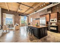 Bright living space featuring exposed brick, wood ceilings, and a kitchen island with seating at 204 Walker Sw St # 319, Atlanta, GA 30313