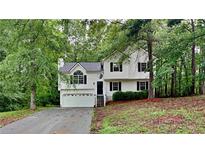 Charming two-story home with a well-maintained yard, garage, and inviting front entrance at 26 Nottingham Nw Dr, Cartersville, GA 30121