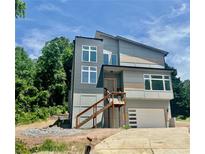 Stunning, modern two-story home with a unique architectural design, a private garage, and wood accents at 4107 Danforth Sw Rd, Atlanta, GA 30331