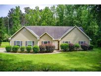 Charming ranch home featuring a well-manicured lawn and mature landscaping at 414 Pamela Ct, Mcdonough, GA 30252