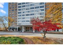 Residential high-rise building with well-maintained landscaping and a circle drive entrance at 215 Piedmont Ne Ave # 303, Atlanta, GA 30308