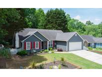Charming single-story home with blue siding, red shutters, well-manicured lawn, and a two-car garage at 5742 Riverside Walk Dr, Sugar Hill, GA 30518