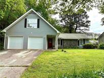 Charming home with a two-car garage and well-maintained lawn with mature trees at 11072 Shannon Cir, Hampton, GA 30228