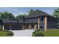 Elegant two-story home with brick and siding exterior, attached garage, and well manicured landscaping at 1330 Twelve Oaks Nw Cir, Atlanta, GA 30327