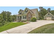 Inviting two-story home featuring stone accents, complementary siding and a detached garage at 46 Grand Georgian Ne Ct, Cartersville, GA 30121