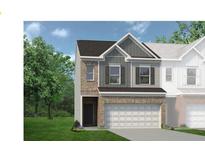 Charming two-story home with a brick and siding facade, complemented by a two-car garage and well-manicured lawn at 106 Jacobs Farm Ln # 42, Lawrenceville, GA 30045