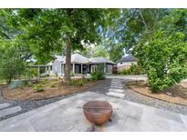 An exterior view of a well-maintained backyard and patio, with a view of the house at 1228 Hosea L Williams Ne Dr, Atlanta, GA 30317