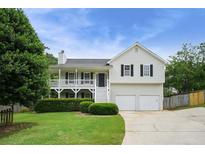 Charming two-story home with a welcoming front porch, tidy landscaping, and a two-car garage at 259 Pine Valley Dr, Powder Springs, GA 30127