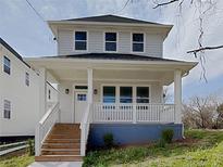 Charming two-story home features a welcoming front porch and beautifully landscaped front yard at 629 Windsor Sw St, Atlanta, GA 30312