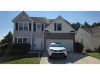 Charming two-story home features a brick facade and attached two-car garage at 771 Franklin Mill Trce, Loganville, GA 30052