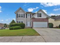 Charming two-story home with a well-manicured lawn and a two-car garage, perfect for Gathering living at 771 Franklin Mill Trce, Loganville, GA 30052