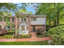 Charming two-story townhome with brick facade, bay window, and landscaped front yard at 1505 September Chase, Decatur, GA 30033