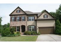 Charming two-story home featuring a brick and siding facade, well-manicured lawn, and a two-car garage at 4020 Alligator Pt, Cumming, GA 30028