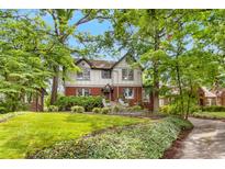 Charming two-story home with landscaped front yard and mature trees at 591 E Morningside Ne Dr, Atlanta, GA 30324