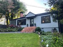 Charming one-story home with brick steps, manicured lawn and mature landscaping at 727 Channing Nw Dr, Atlanta, GA 30318